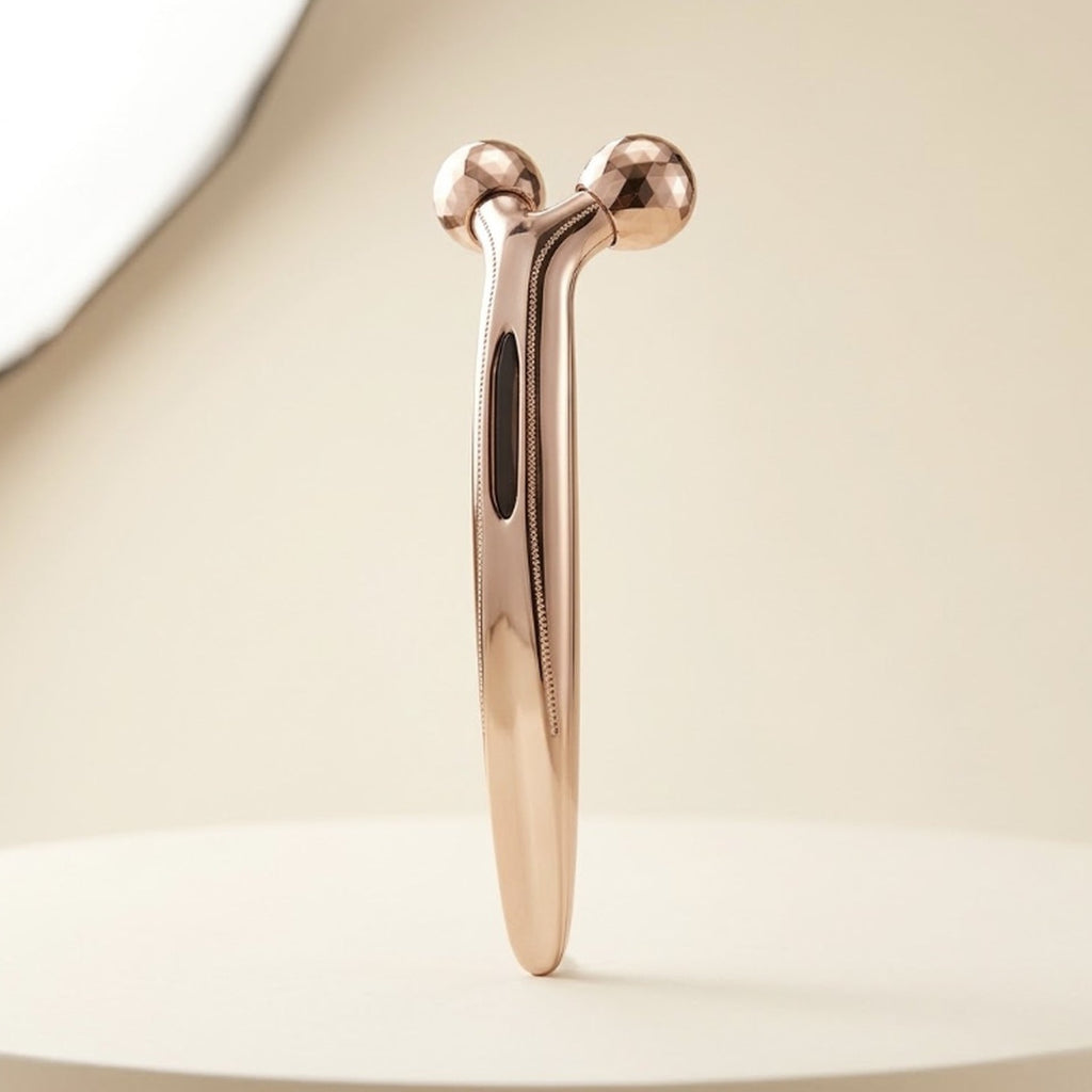 Lumière rose-gold 3D Face Roller on a cream background