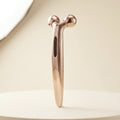 Lumière rose-gold 3D Face Roller on a cream background
